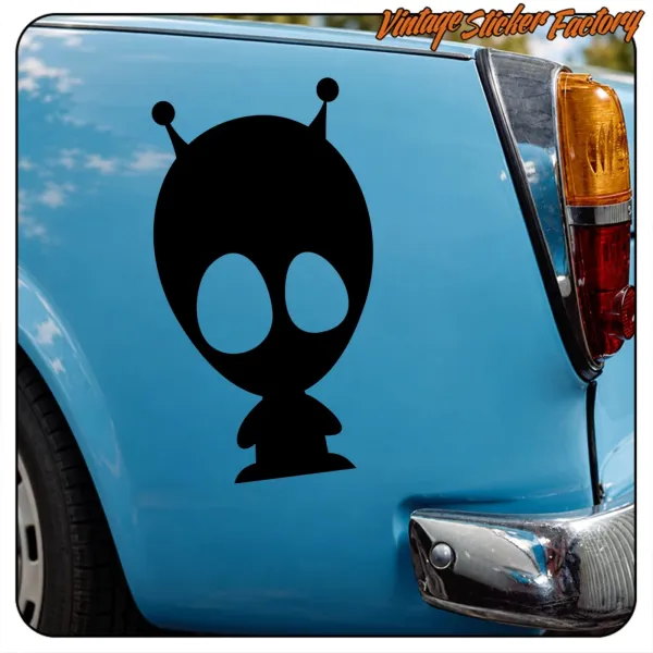 Pegatina de alienígena negro colocada en el lateral trasero de un coche azul