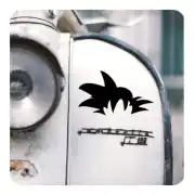 Vinilo negro con silueta de cabello puntiagudo aplicado en una superficie metálica blanca