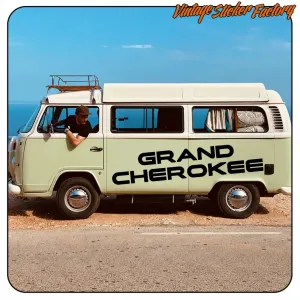 Black «GRAND CHEROKEE» text applied to the side of a camper van
